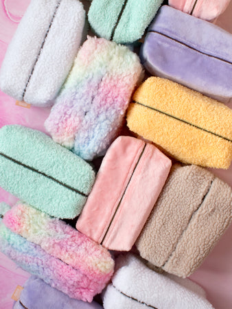 A top view of colourful fluffy makeup bags next to each other in different directions.