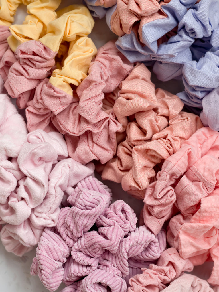 Three diagonal rows of scrunchies in pink and purple colours.