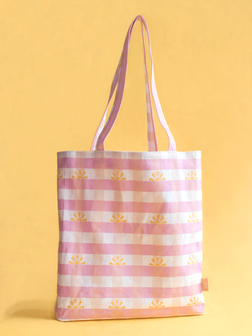 A pink gingham printed tote bag stands against a yellow foreground.