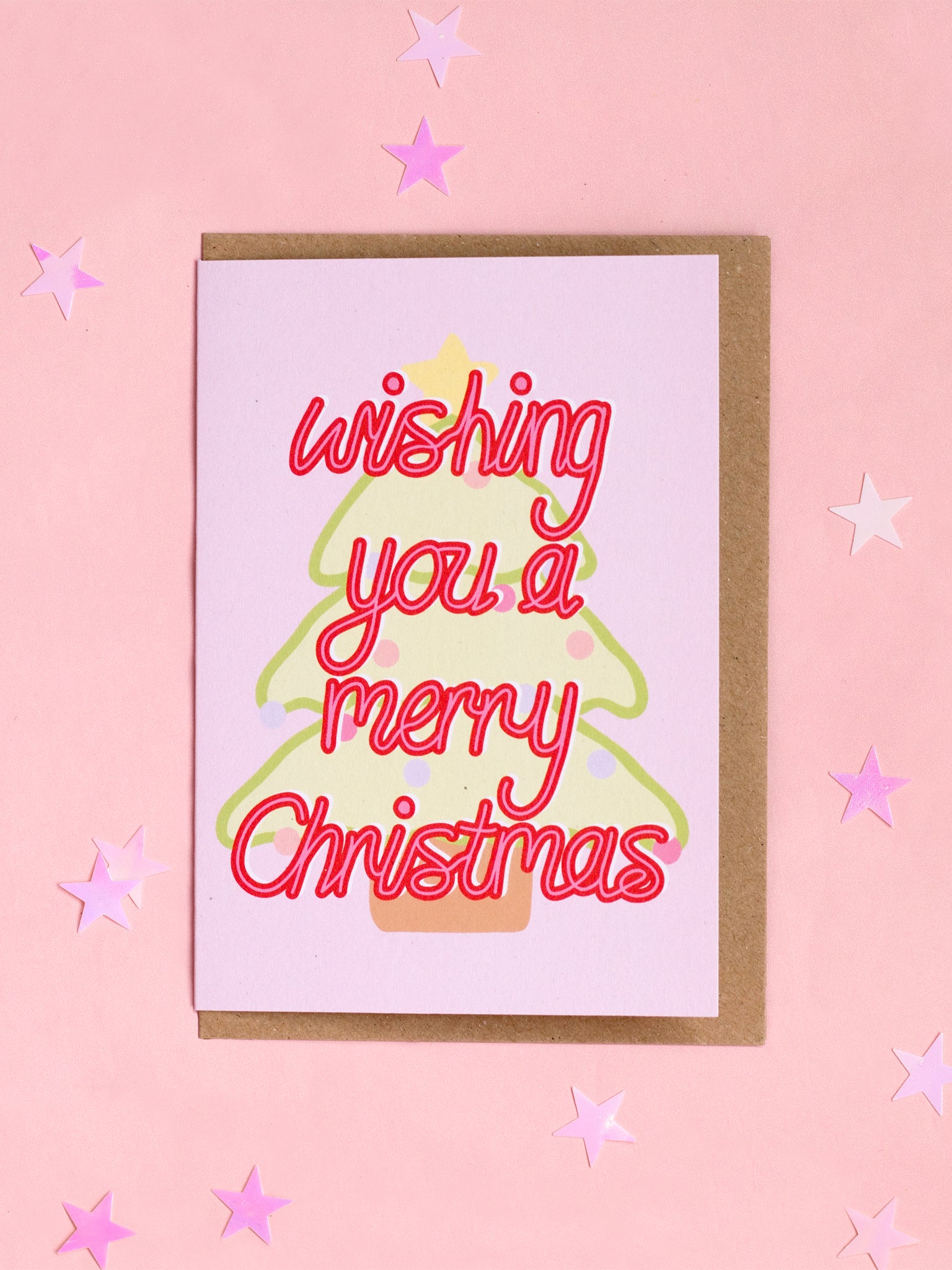 A Christmas card with 'wishing you a merry christmas' in front of a pastel Christmas tree.