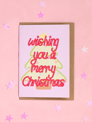 A Christmas card with 'wishing you a merry christmas' in front of a pastel Christmas tree.