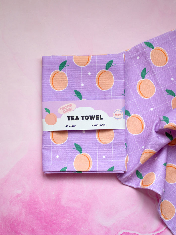 a lilac tea towel wrapped in a creative belly band