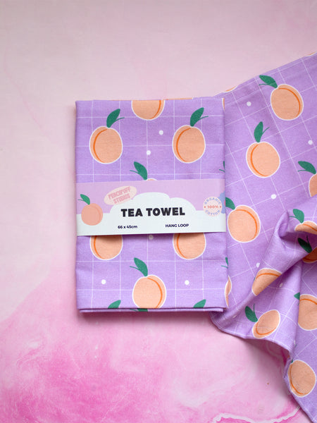 a lilac tea towel wrapped in a creative belly band