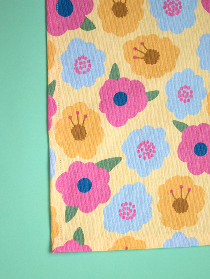 a handamde yellow and colourful floral tea towel