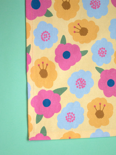 a handamde yellow and colourful floral tea towel