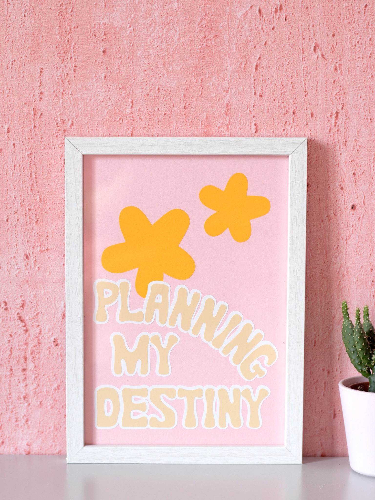 Planning my destiny art print framed in front of a pink textured wall.