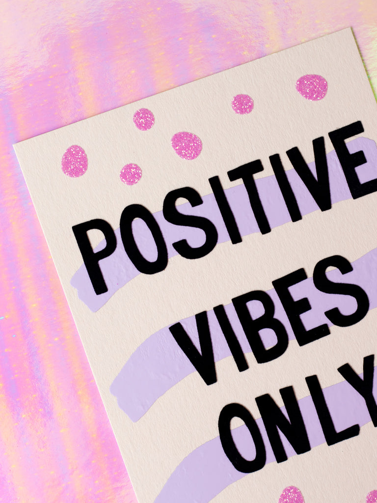 Art print with Positive Vibes Only in flocked font written over three purple strips and pink glittery dots.